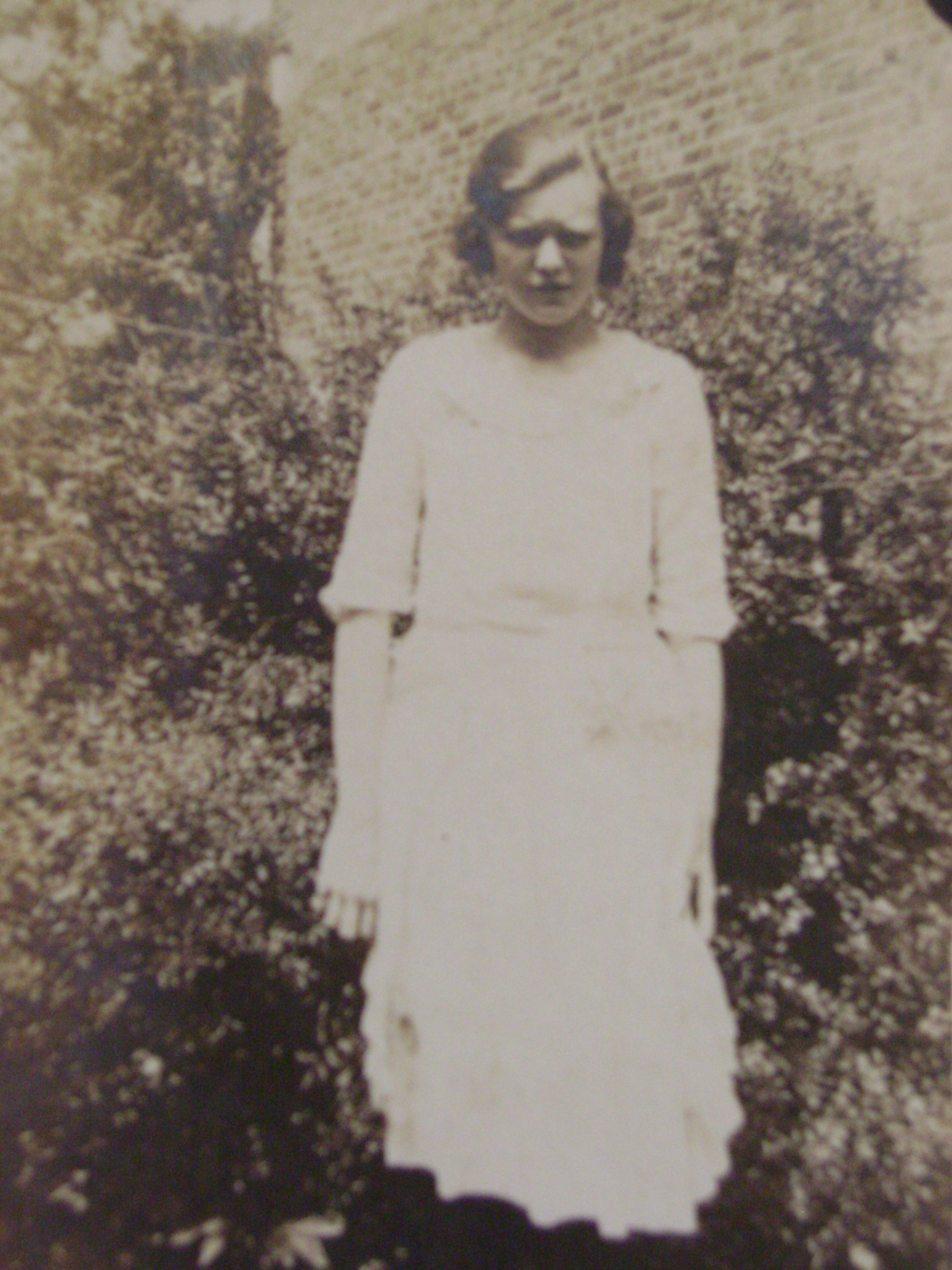 girl standing in greenery